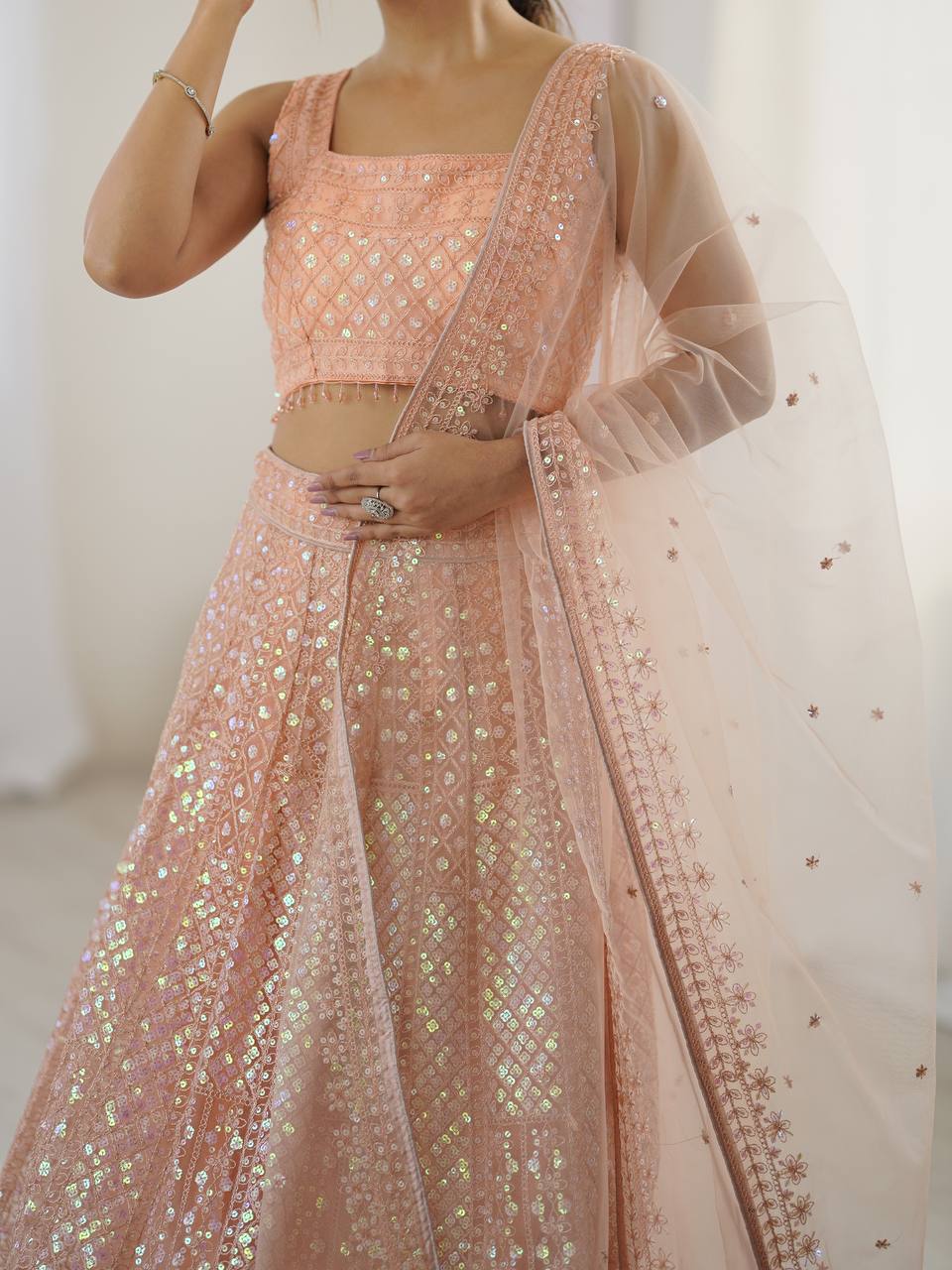 Kruti - Beautiful Pastel Peach Net Lehenga with Rainbow Sequins Fully Stitched