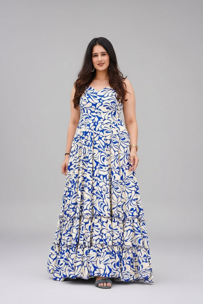 Woman wearing a blue and white patterned dress standing outdoors.