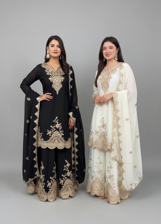 Two women in traditional embroidered outfits standing indoors.