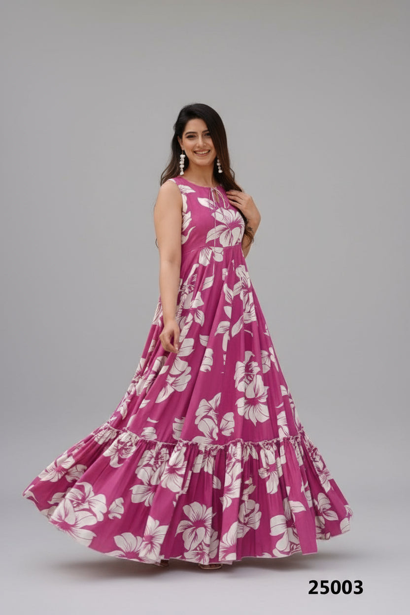 Woman wearing a pink floral dress standing outdoors with plants and a chair in the background.