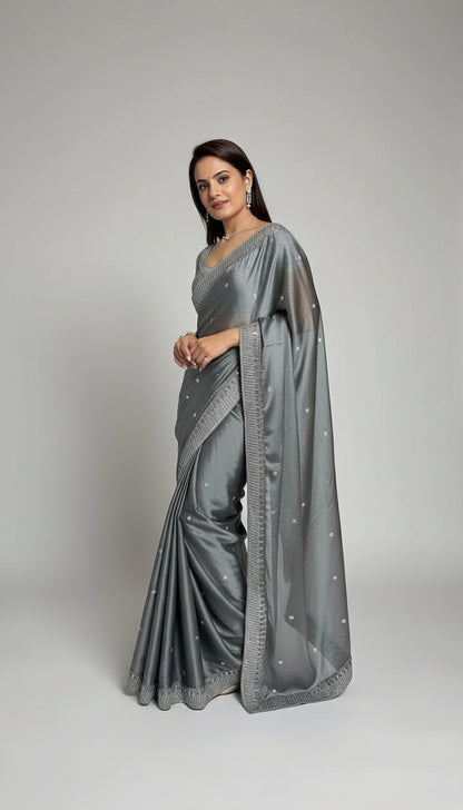 Woman wearing a gray saree with a white background