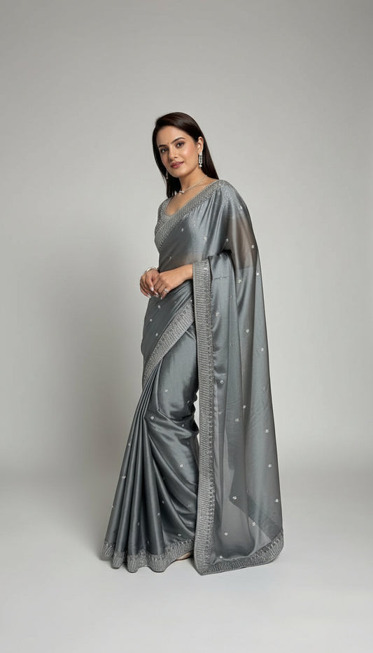 Woman wearing a gray saree with a white background
