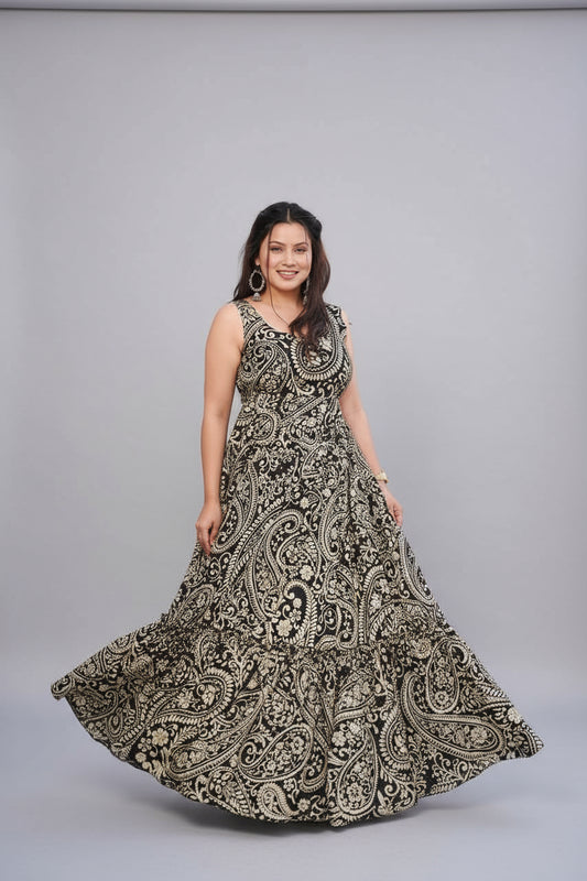 Woman wearing a black and white patterned dress standing outdoors near a pool.