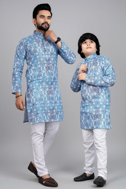 Man and child wearing matching blue floral kurta sets with a brown background