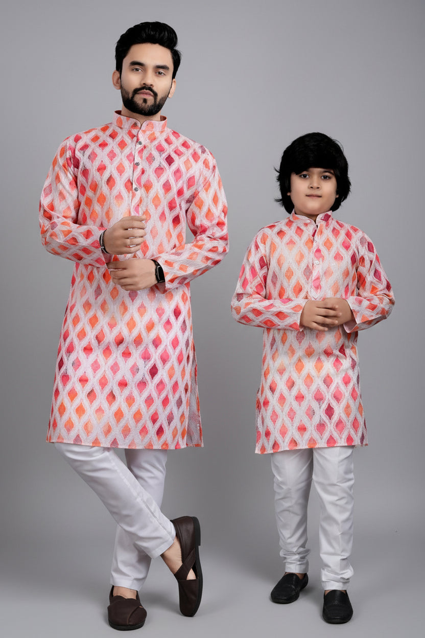 Two individuals wearing matching pink and orange patterned kurta sets with a Venmer logo in the background.