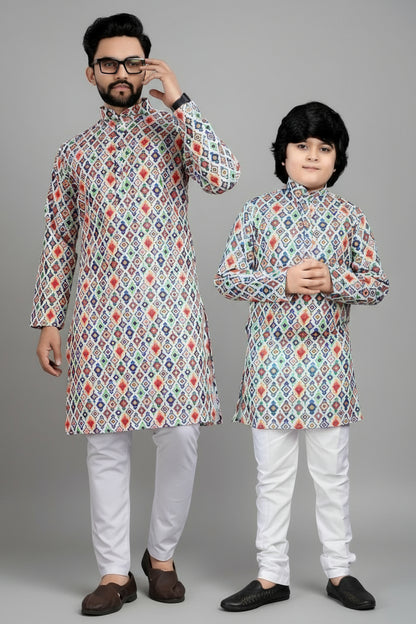 Two individuals wearing matching patterned kurta sets against a wooden background.