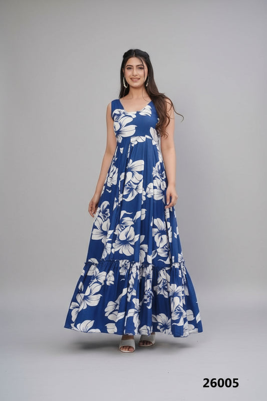 Woman wearing a blue floral dress standing by a poolside.
