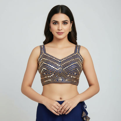 Decorative blue and gold top with embellishments on a white background
