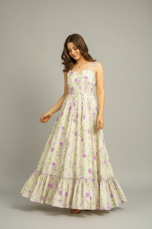 Woman wearing a floral dress standing outdoors.